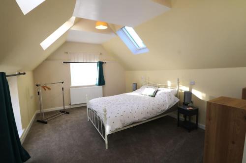 a bedroom with a white bed and a window at The Old Wagon & Horses 19th Century Beer House in Glastonbury