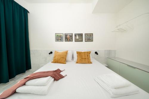 a bedroom with a bed with a green curtain at Mooeve Exarchia in Athens