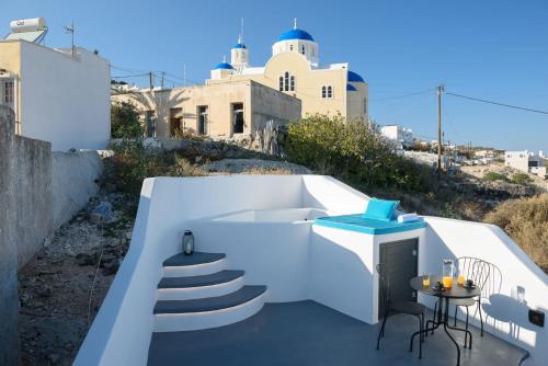 a balcony with stairs and a tub and a table at Santorini traditional 1Bd apt with private hot tub in Fira