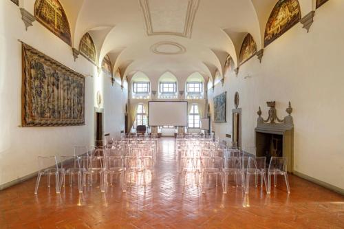 a room with chairs and a projection screen in a building at Tenuta di Artimino member of Meliá Collection Wine Resort in Artimino