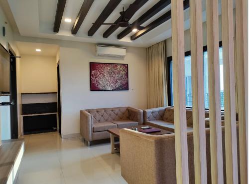 a living room with a couch and a table at Sambhabana Hotel & Suites in Tarapith