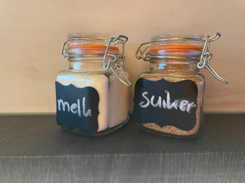 two glass jars filled with food sitting on a shelf at Eco-lodge locatie Dalfsen in Dalfsen