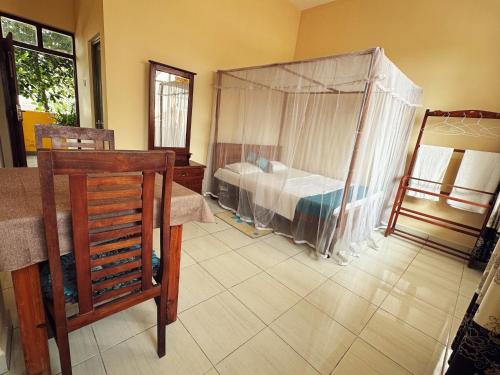 a bedroom with a bed with a tent in it at New Golden Bay Resort Weligama in Weligama