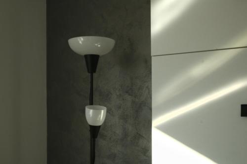 a black pole with a white light on a wall at TheRefuge in Curtea de Argeş