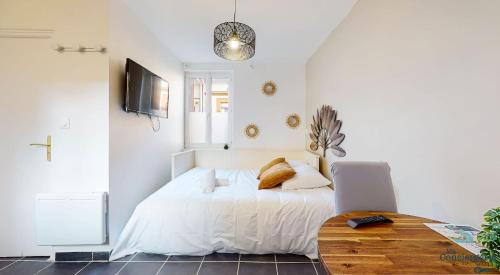 - une chambre avec un lit, une table et un ordinateur portable dans l'établissement Pouvillon - 10min du Zenith - Théâtre - Musée, à Toulouse