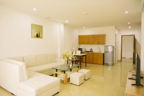 uma sala de estar com um sofá e uma mesa em GEM Apartment & Hotel em An Khê