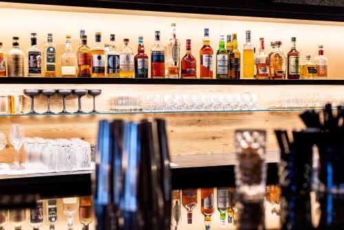 a bar with a lot of bottles of alcohol at Best Western Plus Parkhotel Maximilian Ottobeuren in Ottobeuren