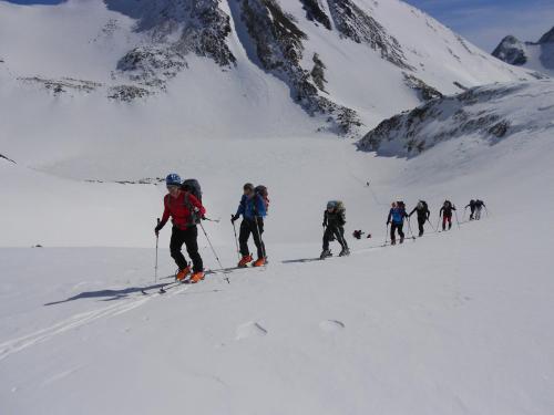 a group of people cross country skiing in the snow at Hotel Estanys Blaus in Tavascan