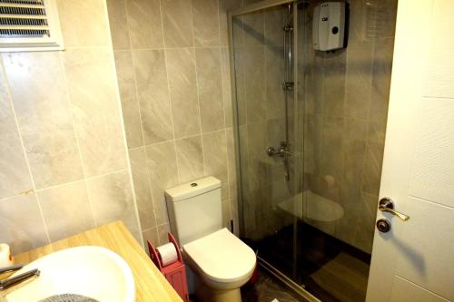 a bathroom with a shower and a toilet and a sink at LYSUİT in Kırac