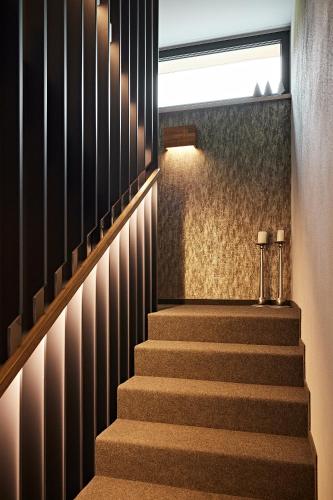 a staircase with two candles on the side of a building at Siplinger Suites - Ferienwohnungen - Sauna und Fitness in Balderschwang