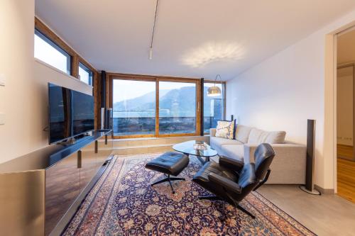 a living room with a couch and a table at Lakefront Suite 148 by we rent in Zell am See