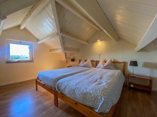 a bedroom with a large bed in an attic at Quinta da Estrela in Ponte Nova
