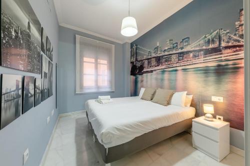 a bedroom with a bed with a painting on the wall at ISG Apartments Apartamento cerca de la Catedral in Seville