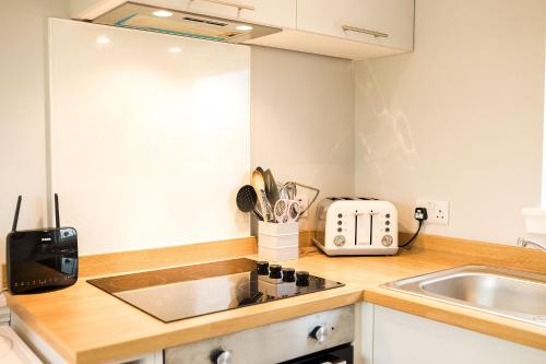 a kitchen with a sink and a counter top at Beth's Bothy in Gatehouse of Fleet