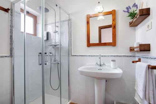 a bathroom with a sink and a shower at Las Raíces in Pájara