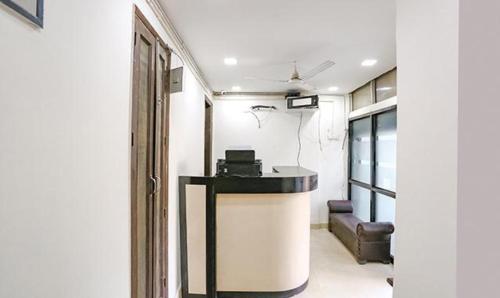 a room with a table and a couch in a room at FabExpress Premium Room I in New Delhi