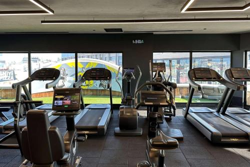 a gym with treadmills and ellipticals in a building at Ramada Plaza By Wyndham Istanbul City Center in Istanbul