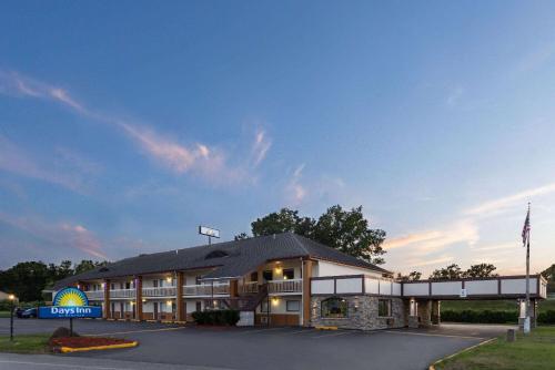 a hotel building with a sign in front of it at Days Inn by Wyndham Queensbury/Lake George in Queensbury
