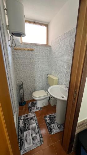 a bathroom with a toilet and a sink at STANZA CORSICA in Alghero