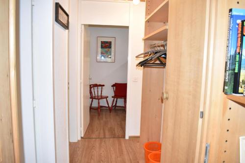 a hallway with a table and chairs in a room at Gentiana (463 Li) 4-ZW in Valbella