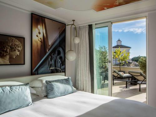 a bedroom with a bed and a view of a patio at Sofitel Roma Villa Borghese in Rome
