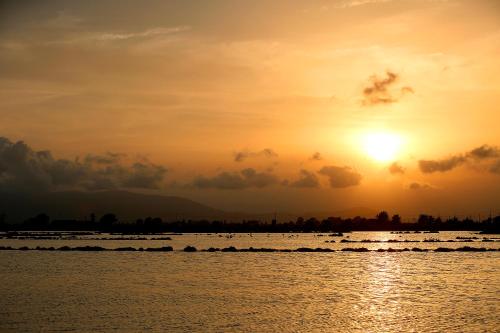 a sunset over a body of water at Hotel Montsia in Amposta