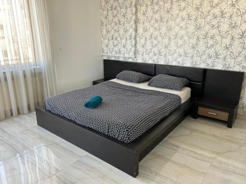 a bed in a bedroom with a blue hat on it at Bucharest City Center Apartment in Bucharest