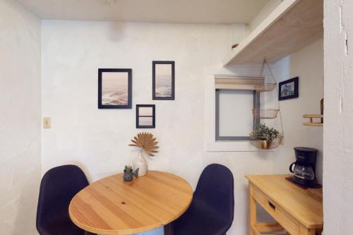 a dining room with a wooden table and chairs at Surf Casita in Seaside