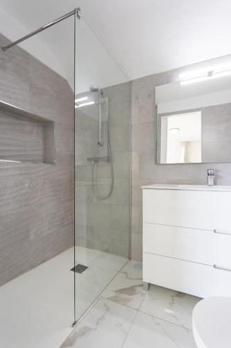a bathroom with a glass shower and a sink at Home2Book Bright Studio Ocean View Tabaiba in Tabaiba