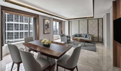 a living room with a dining table and chairs at Grand Hyatt Jakarta in Jakarta