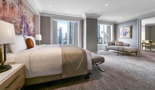 a bedroom with a large bed and a large window at Grand Hyatt Jakarta in Jakarta