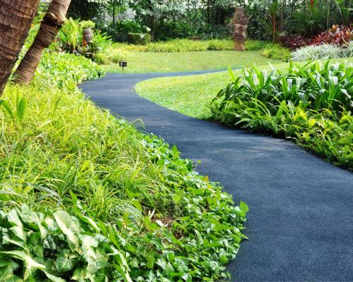a path through a park with plants and trees at Grand Hyatt Jakarta in Jakarta