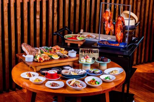 a table with plates of food on top at Grand Hyatt Jakarta in Jakarta
