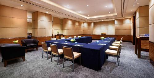 a conference room with a long blue table and chairs at Grand Hyatt Jakarta in Jakarta