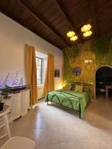 a bedroom with a green bed and a fireplace at The Flower Garden in Castellammare di Stabia