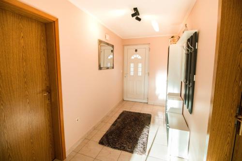 a hallway with a refrigerator and a door at Apartment Tina in Bibinje