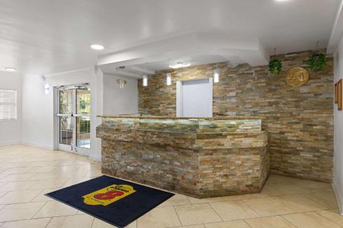 a bar in a room with a brick wall at Super 8 by Wyndham Harbison/Parkridge Hospital in Columbia