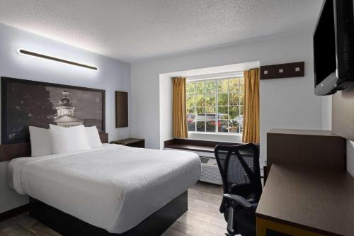 a hotel room with a bed and a window at Super 8 by Wyndham Harbison/Parkridge Hospital in Columbia