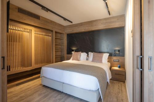 a bedroom with a white bed and wooden walls at 507 Athens in Athens