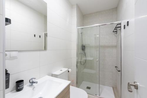 a bathroom with a shower and a sink and a toilet at Market Martinez de la Riva II in Madrid