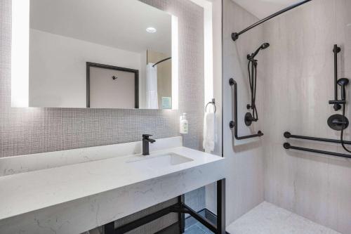 a white bathroom with a sink and a mirror at La Quinta Inn & Suites by Wyndham Yucaipa in Yucaipa