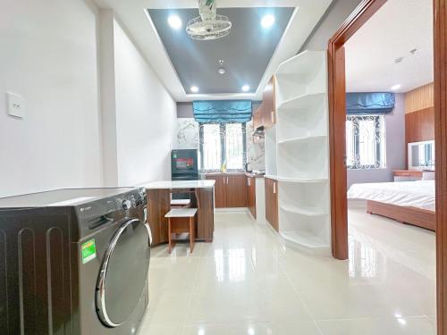 a bathroom with a washer and dryer in a room at Milanesa Hotel and Apartment in Vung Tau