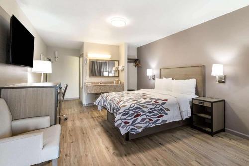 a hotel room with a bed and a desk at Baymont by Wyndham Socorro in Socorro