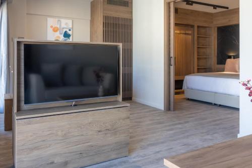 a large flat screen tv in a room with a bed at 507 Athens in Athens