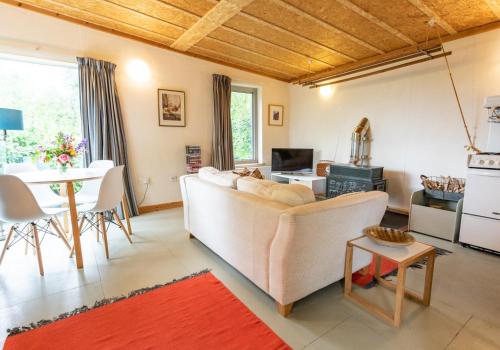 a living room with a couch and a table at Y Caban - Cosy Cabin in Pembrokeshire in Saint Dogmaels
