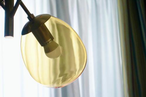 a large round mirror hanging from a ceiling at Blume Cruz Suites in Madrid
