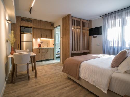 a bedroom with a bed and a table and a kitchen at 507 Athens in Athens