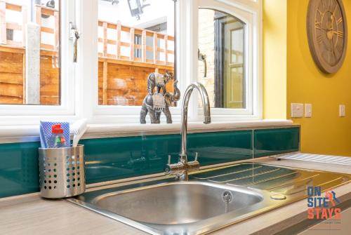 a kitchen sink with a toy sitting in a window at OnSiteStays - Stylish 4 BR House with Beautiful Outdoor Space, Wi-Fi & Smart TVs in Dartford