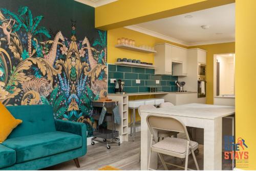 a kitchen and dining room with a colorful wall at OnSiteStays - Stylish 4 BR House with Beautiful Outdoor Space, Wi-Fi & Smart TVs in Dartford