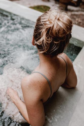 a woman sitting in a pool of water at Hôtel Expérience - Quartier Des Marinas in Magog-Orford